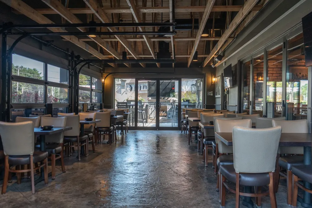 The Barrels and Boards dining room with tables set beneath warm wood-beamed ceilings
