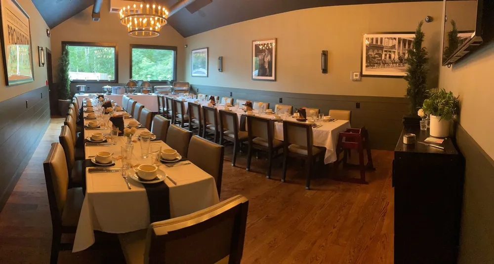 A long private dining room set with white tablecloths for a group event
