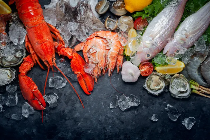 Fresh lobster, oysters and shellfish arranged on ice